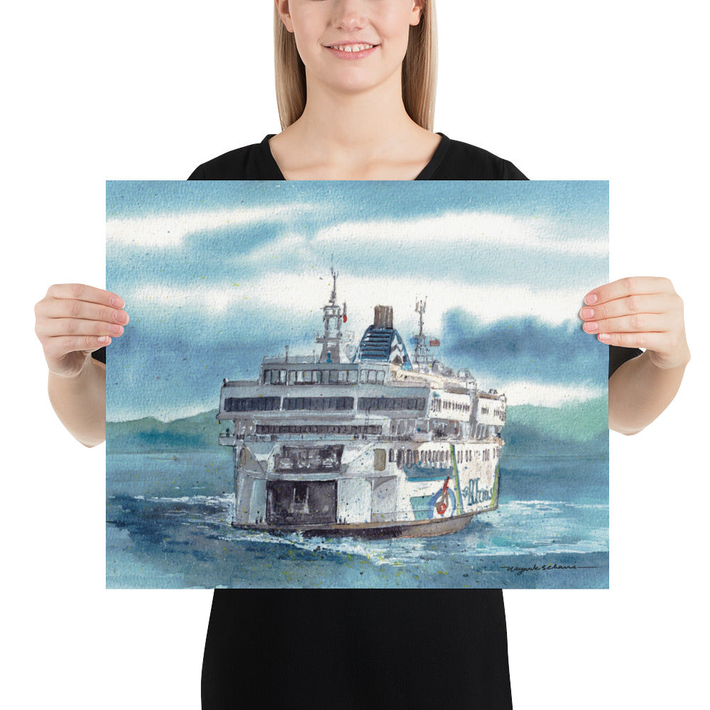 Model in a black top holding the unframed Coastal Inspiration Arriving at the Dock landscape print; stern view of Coastal Inspiration nearing the dock through textured blue water, with a trailing wake, layered clouds and distant green mountains.