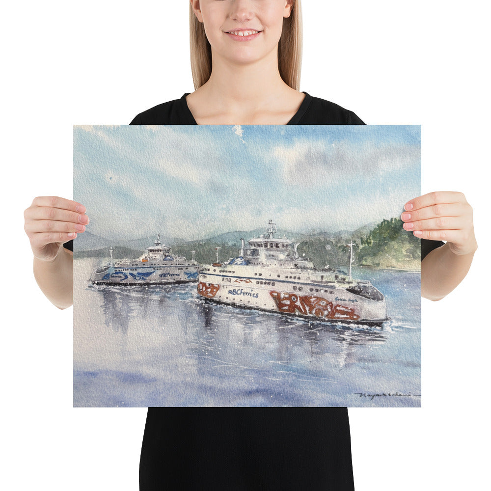 Model in a black top holding the unframed Salish Eagle & Salish Raven in Active Pass landscape print; Salish Eagle and Salish Raven passing in Active Pass on reflective blue water, with forested shoreline, soft mountains and a pale coastal sky.