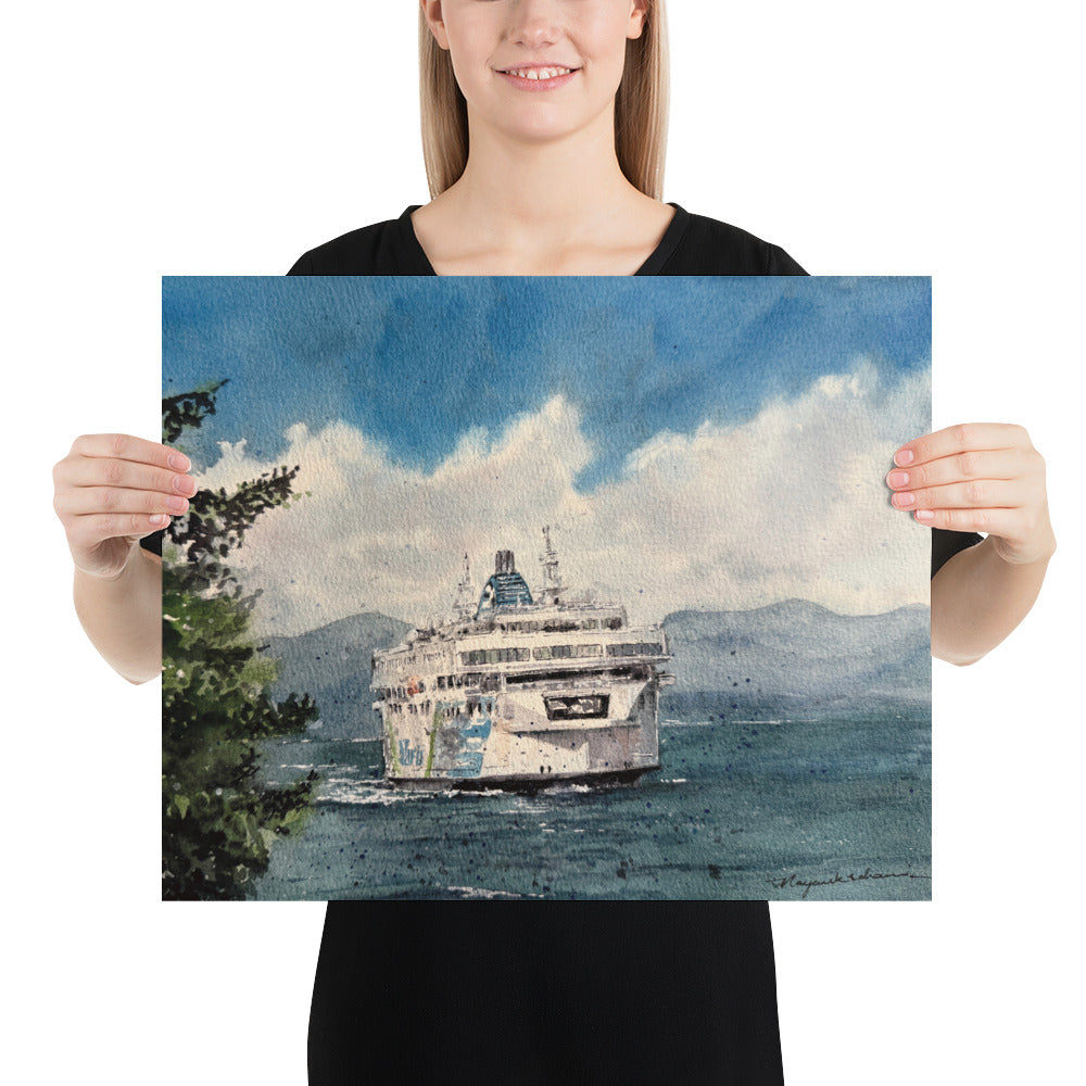 Model in a black top holding the unframed Coastal Inspiration Approaching Duke Point landscape print; Coastal Inspiration approaching Duke Point head-on across deep blue water, with an evergreen foreground, distant mountains and billowing white clouds.