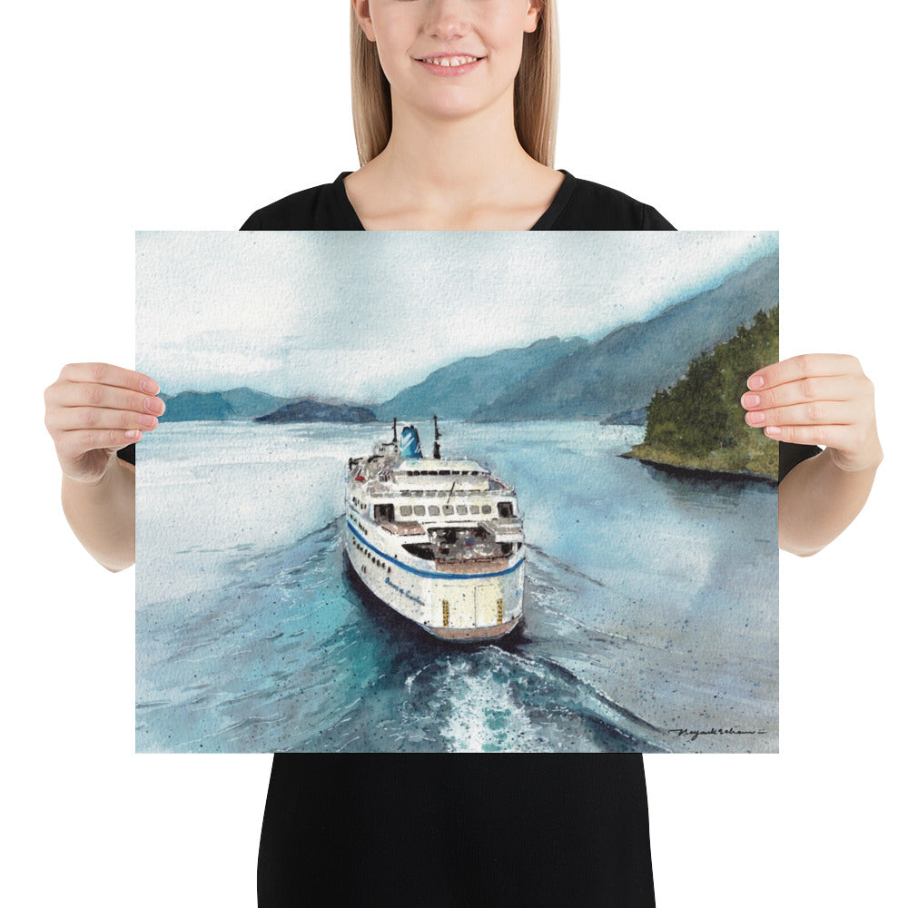 Model in a black top holding the unframed Queen of Cowichan Departing Horseshoe Bay landscape print; stern view of Queen of Cowichan departing Horseshoe Bay through calm blue and turquoise water, leaving a bright wake between forested shoreline and misty coastal mountains.